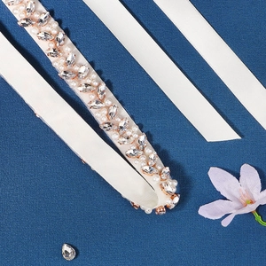 Detail of bridal belt featuring marquise rhinestones and pearls on ivory ribbon