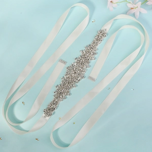 Detailed close-up of intricate hand-sewn rhinestones and crystals on a bridal wedding belt