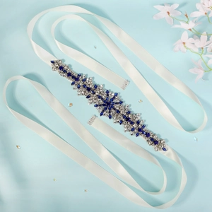 Macro detail of bridal belt featuring blue and clear rhinestones in a vintage floral pattern