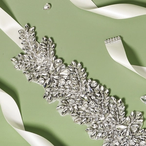Elegant bridal rhinestone belt with leaf patterns on white satin for wedding dresses