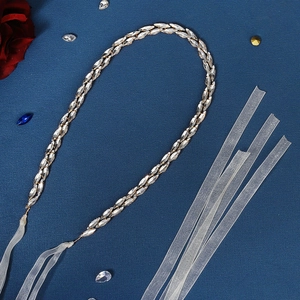 Close-up of sparkling double-row marquise rhinestone bridal belt with sheer white ribbons