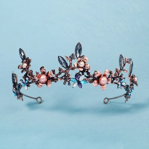 Detailed close-up of a vintage bridal tiara with colorful crystals and pink pearls