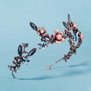 Detail of baroque bridal crown with pink pearls and colorful floral gemstone patterns