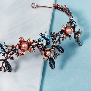 Detailed close-up of a Baroque bridal tiara featuring pink pearls and colorful crystals