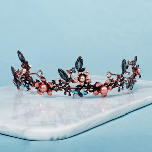 Detailed close-up of Baroque bridal tiara featuring blue crystals and pink pearls