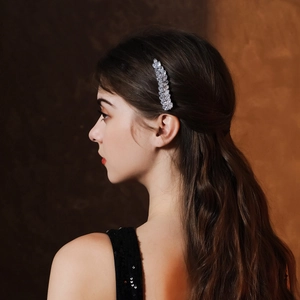 Elegant silver wheat ear hair clip with sparkling zircons worn by a woman on the side