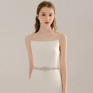 Détail de la ceinture de mariée avec strass étincelants sur une robe de mariée blanche