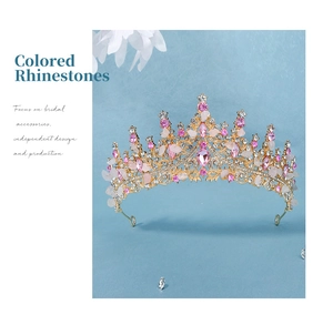 Detail of handmade gold bridal crown featuring natural pink crystals and sparkling rhinestones