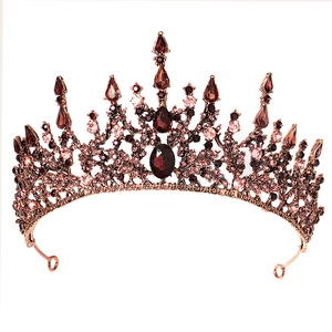 Baroque bridal crown with vintage bronze frame and red crystal stones on white background