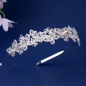 Close-up detail of silver butterfly headband with hollow pattern and sparkling rhinestones