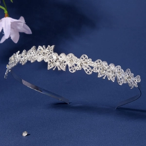 Detailed close-up of a silver hollow butterfly headband with sparkling rhinestones