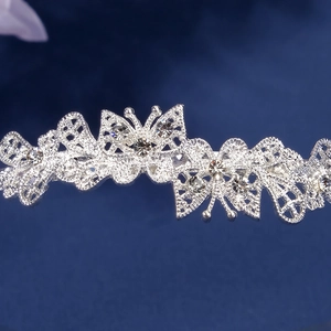 Macro view of silver butterfly headband featuring hollow design and clear rhinestones