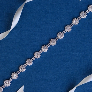 Detail of silver bridal waist chain featuring sparkling sunflower crystal links
