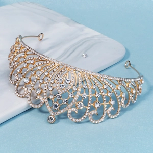 Detailed close-up of a luxury gold bridal crown with crystals on a marble base