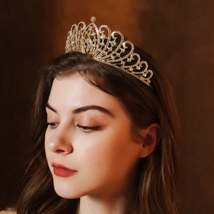 Detailed view of luxury gold bridal crown with white rhinestones and iridescent gems