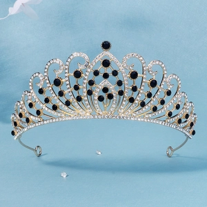 Close-up of golden bridal crown with intricate filigree and black crystal detailing