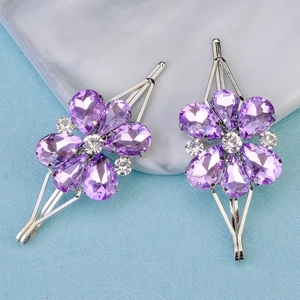 Detail of luxury purple crystal flower hair clips with silver metal frame and white stones