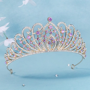 Close-up of golden bridal crown with purple rhinestones and intricate vine details