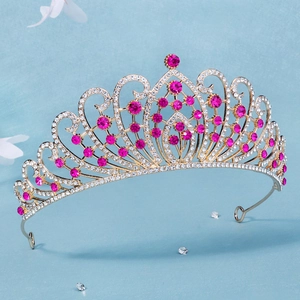 Close-up of golden vintage bridal crown featuring luxury pink rhinestones and crystals