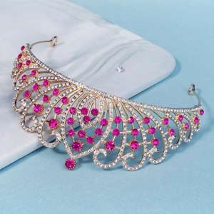 Detailed macro view of luxury gold bridal crown with pink rhinestones and crystals