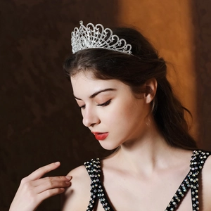 Elegant silver bridal tiara with rhinestones worn by a model for a wedding look