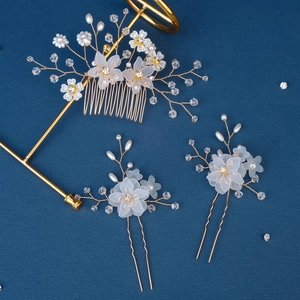 Exquisite bridal hair accessories set featuring white flowers, pearls, and gold wiring