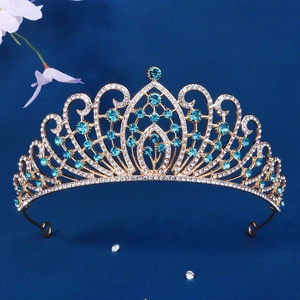 Luxury gold bridal crown with blue rhinestones for weddings and pageants on dark background
