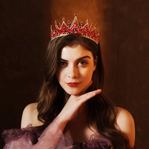 Detailed view of model wearing a luxury bridal tiara with red crystals and gold frame