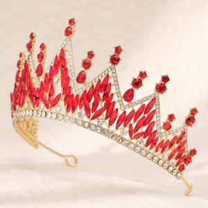 Detailed side view of luxury bridal tiara with red crystals and gold metal frame