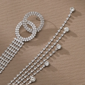 Orecchini pendenti argento con nappe di strass e design a doppio cerchio intrecciato