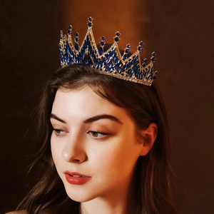 Close-up of a vintage bridal crown with dark blue gemstones and intricate gold filigree