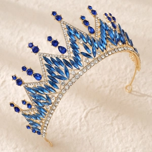 Macro side view of luxury bridal crown with royal blue rhinestones and gold metal base