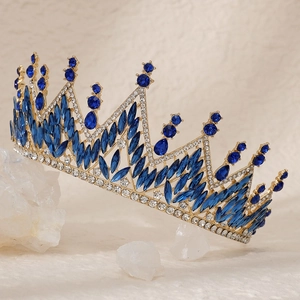 Detailed close-up of a luxury gold bridal crown with dark blue marquise rhinestones