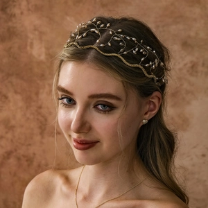 Close-up of handmade golden crown headband with elegant white pearls and crystals