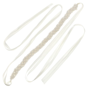 Detail of hand-woven pearl belt with white satin ribbons for elegant party dress decor