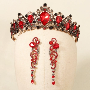 Close-up of vintage baroque crown and earrings with red and black crystal details