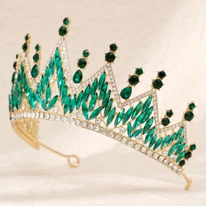 Macro detail of luxury vintage golden bridal crown with emerald green gems and zircons