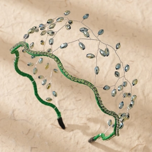 Detail of handmade crystal crown headband with green rhinestones and blue beads