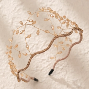Macro detail of handmade golden crown headband with champagne crystal beads and rhinestones