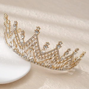 Detailed side view of golden bridal crown with sparkling marquise cut crystals on white base