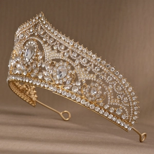 Detail view of golden bridal crown with intricate hollow weaving and sparkling rhinestones