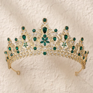 Détails d'une couronne de mariée dorée avec pierres vert émeraude et zircons blancs