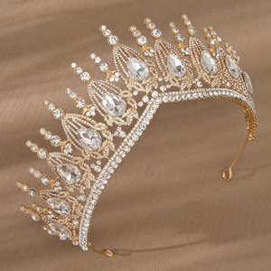 Detail of luxury gold bridal crown featuring white rhinestones and pear-shaped crystals