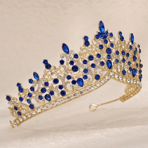 Detailed side view of luxury bridal crown with deep blue crystals and gold镂空 metalwork