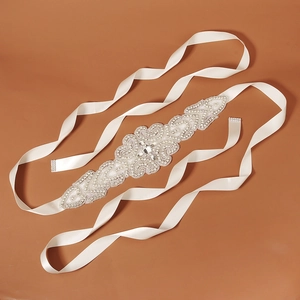 Exquisite bridal sash with intricate rhinestone applique on soft white satin ribbon