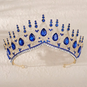 Detail of bridal tiara with large pear-shaped blue crystals and gold setting