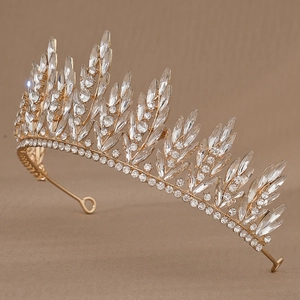 Detailed side view of golden bridal crown with sparkling clear crystal wheat patterns