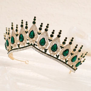 Detail of luxury bridal crown with emerald green gemstones and gold hollow metalwork