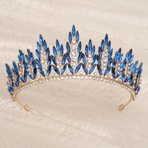 Close-up of golden tiara featuring dark blue marquise crystals and clear rhinestones