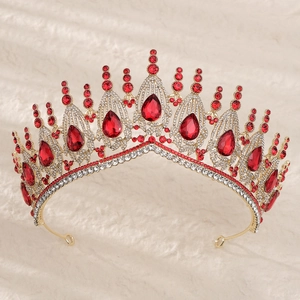 Luxurious gold bridal crown with sparkling white crystals and large red teardrop gemstones